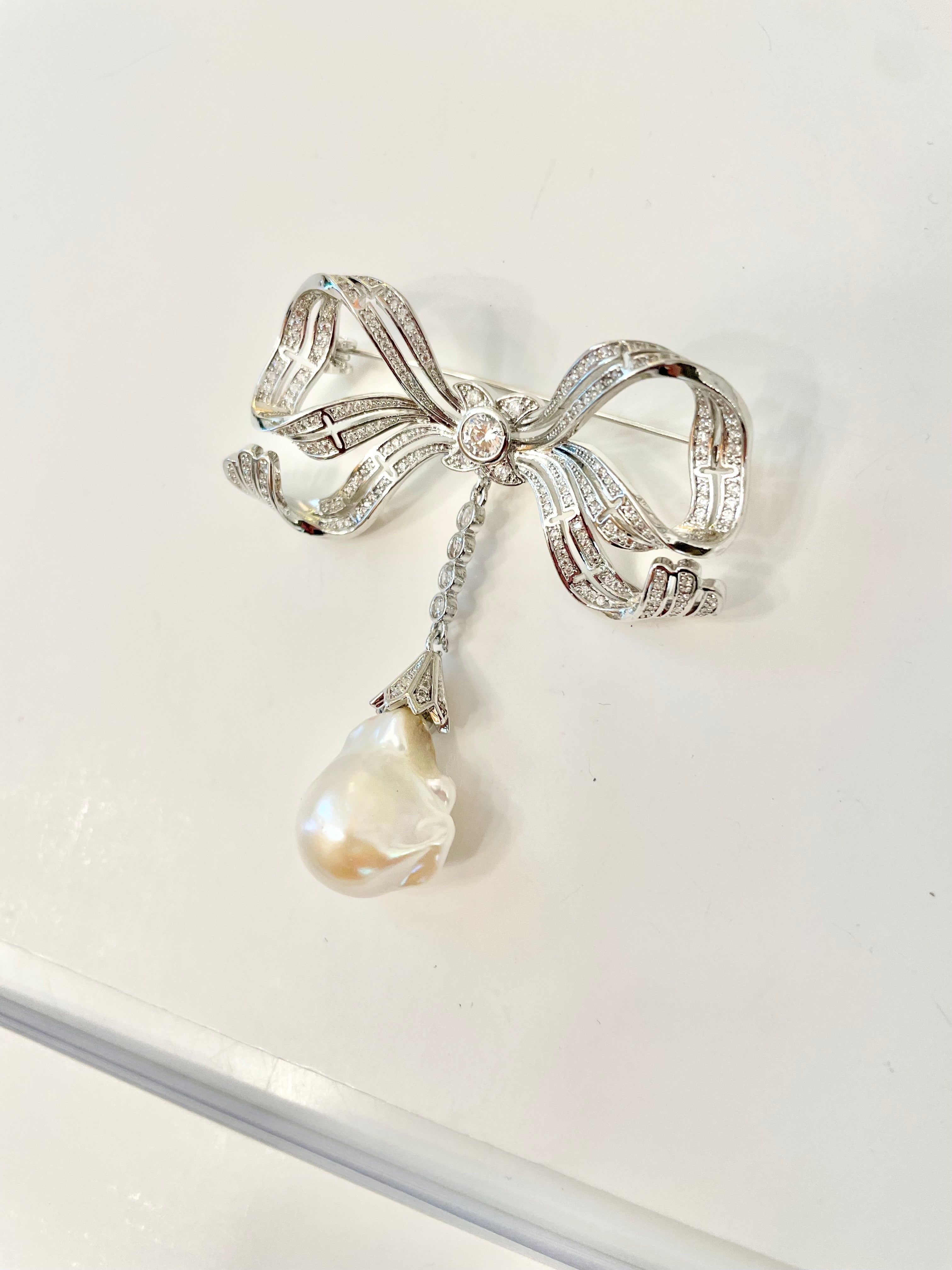 The most charming baroque fresh water pearl bow brooch.... so divine.