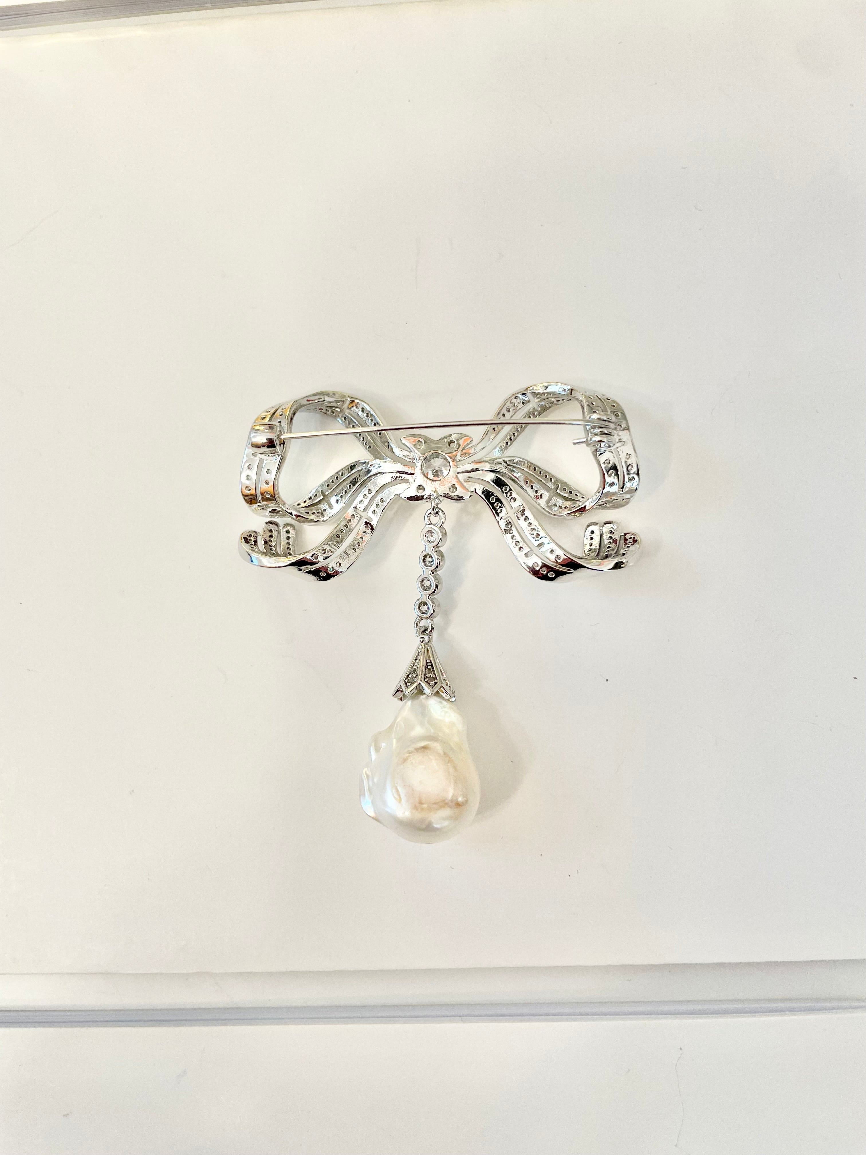 The most charming baroque fresh water pearl bow brooch.... so divine.