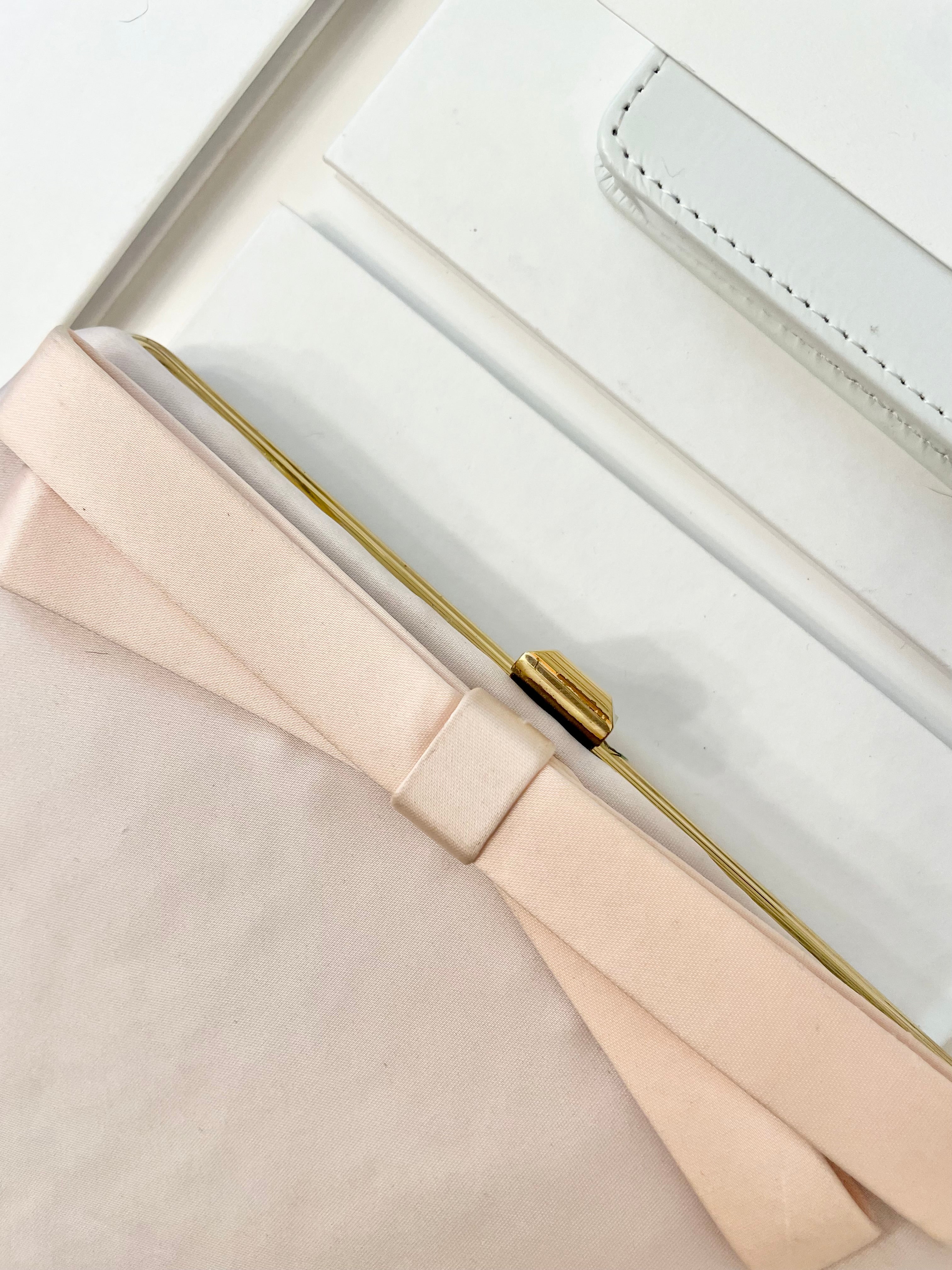 Vintage flirty gal and her love of soft pink.. this satin bow clutch is so pretty!