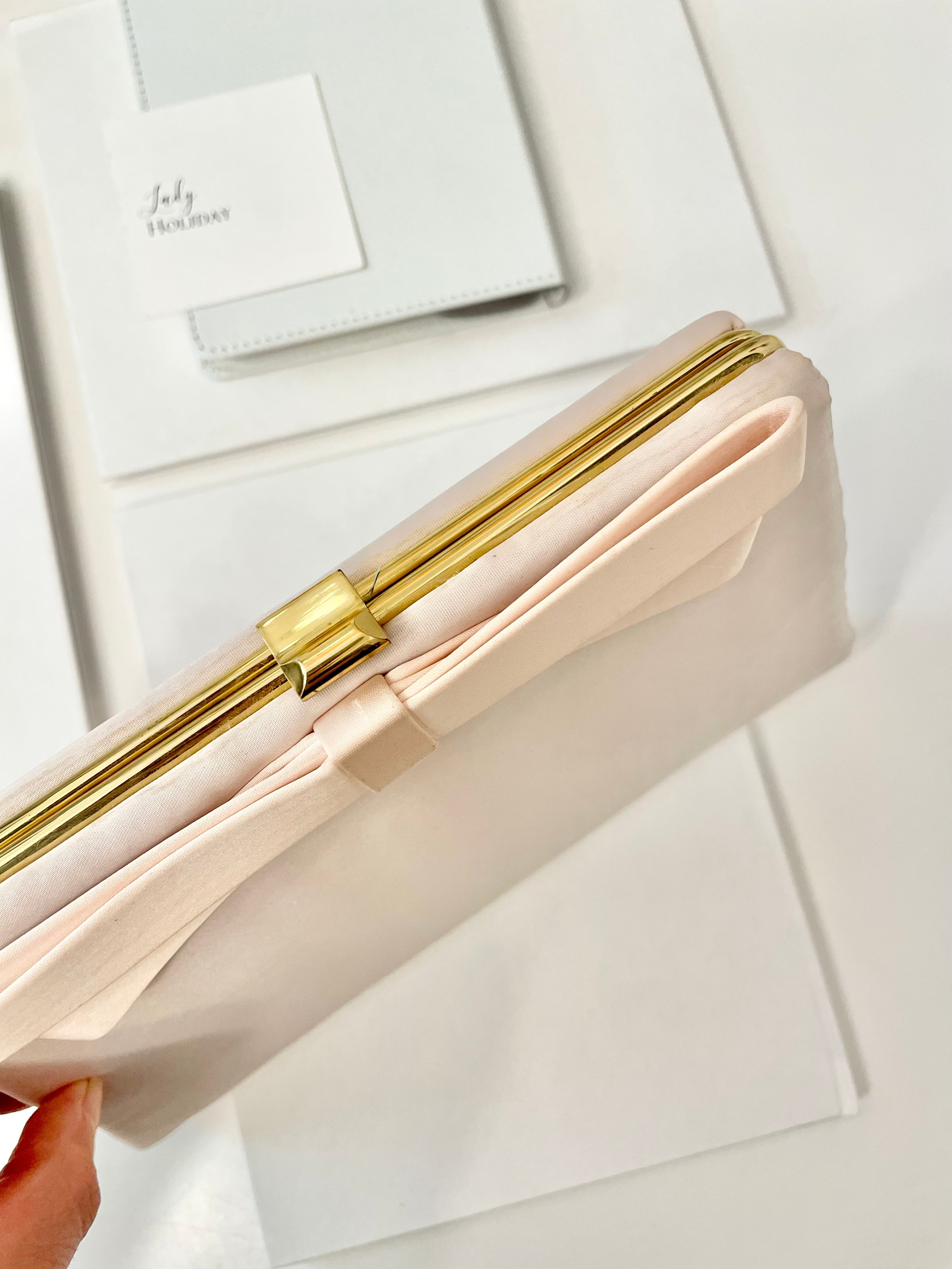 Vintage flirty gal and her love of soft pink.. this satin bow clutch is so pretty!