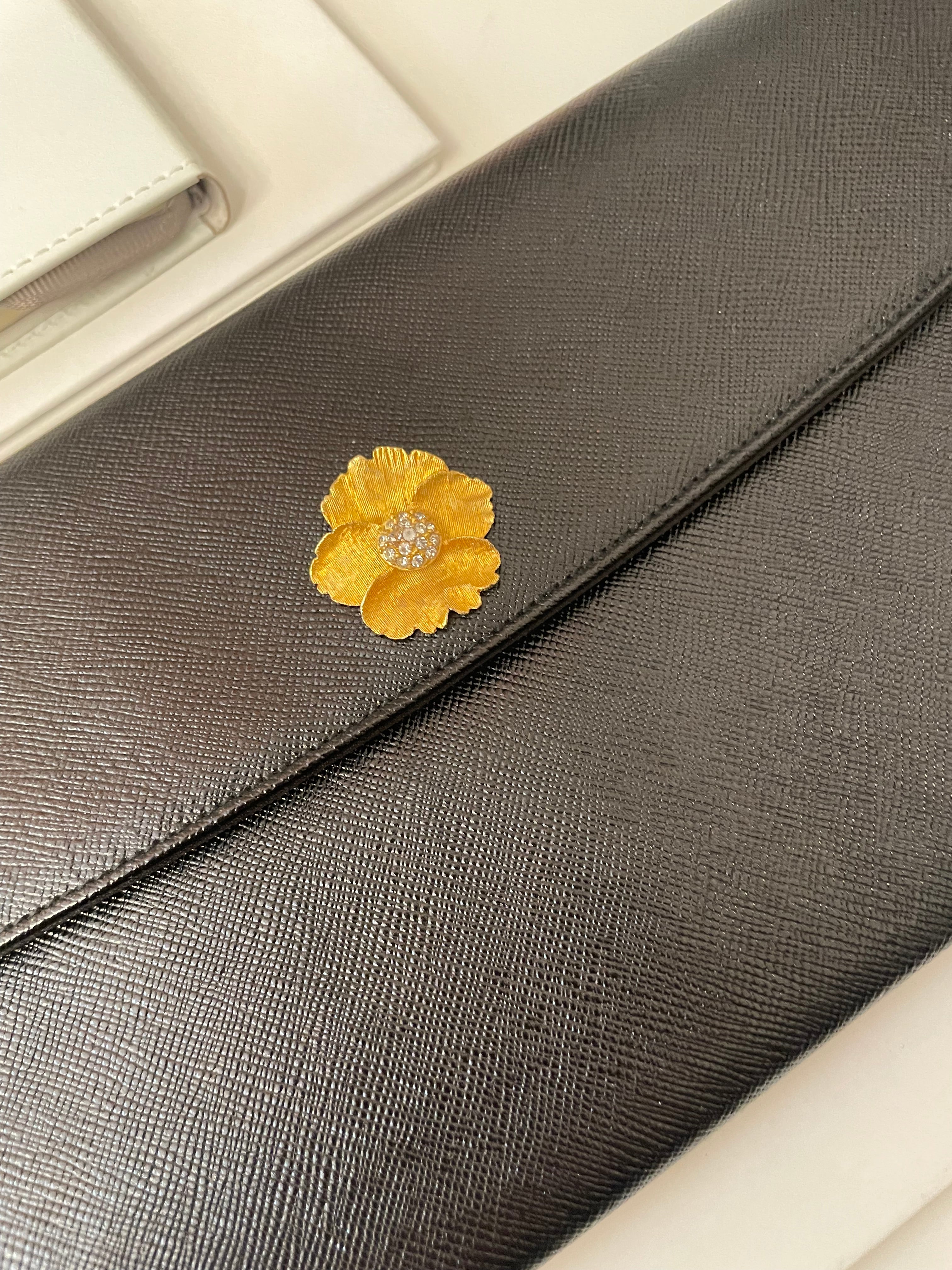 Vintage 1960's Prestige noir clutch bag for Saks Fifth Avenue, adorned with chic gold flower..so lady like!