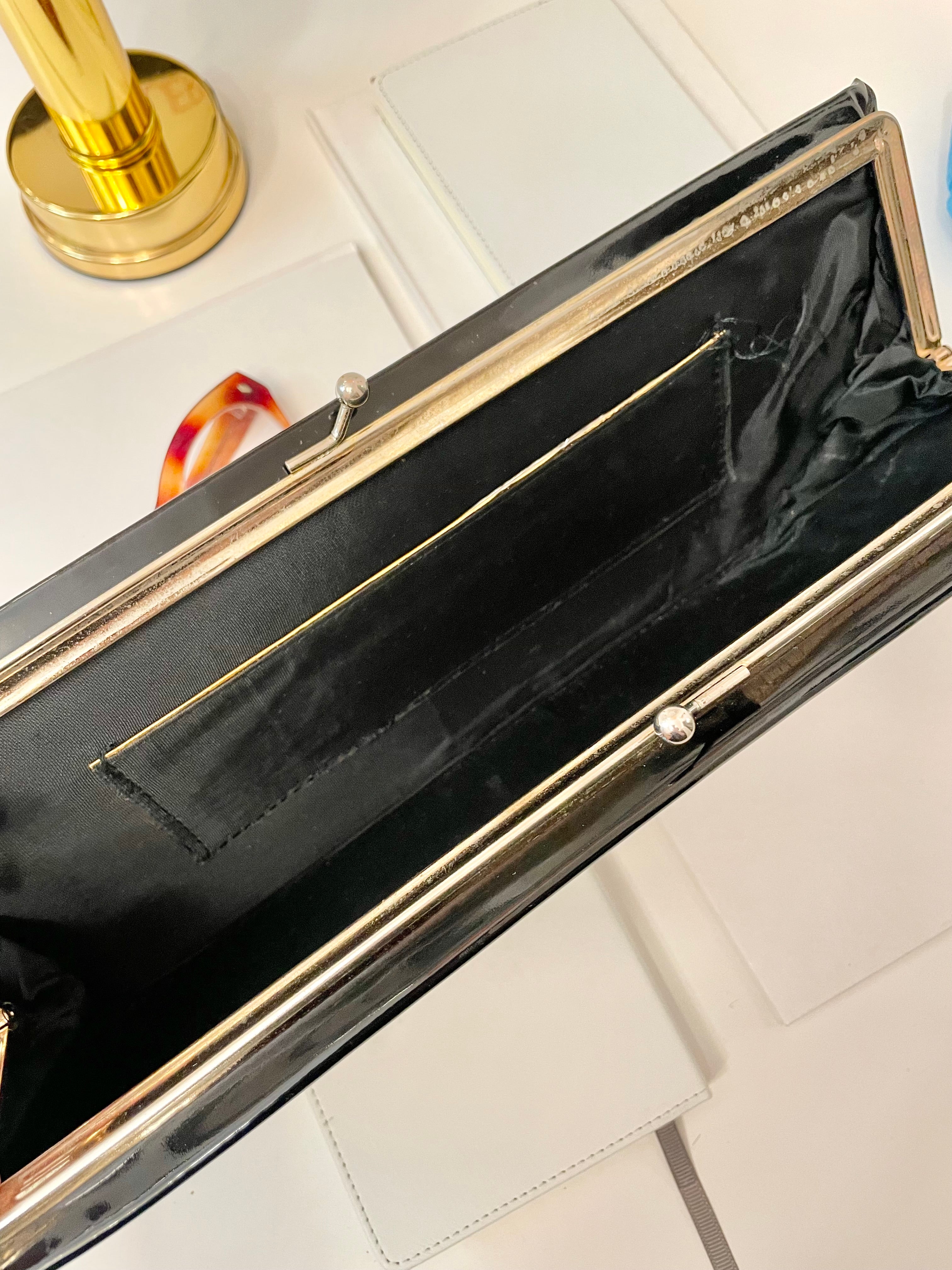 The Socialite and her love of a classic.. this sleek, long, patent leather clutch bag is a must for any lady!