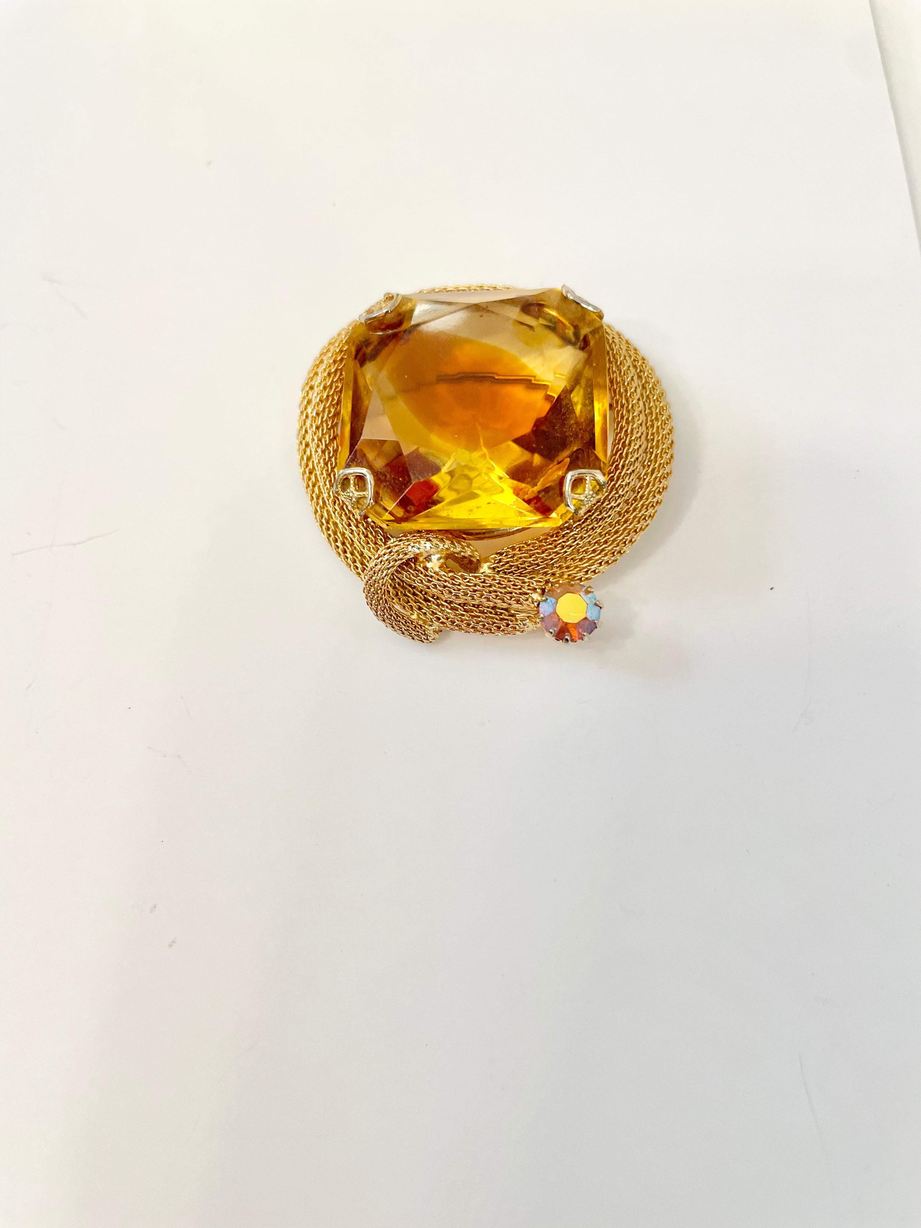 Rich and oh so classy! This stunning citrine colored glass brooch is truly chic!