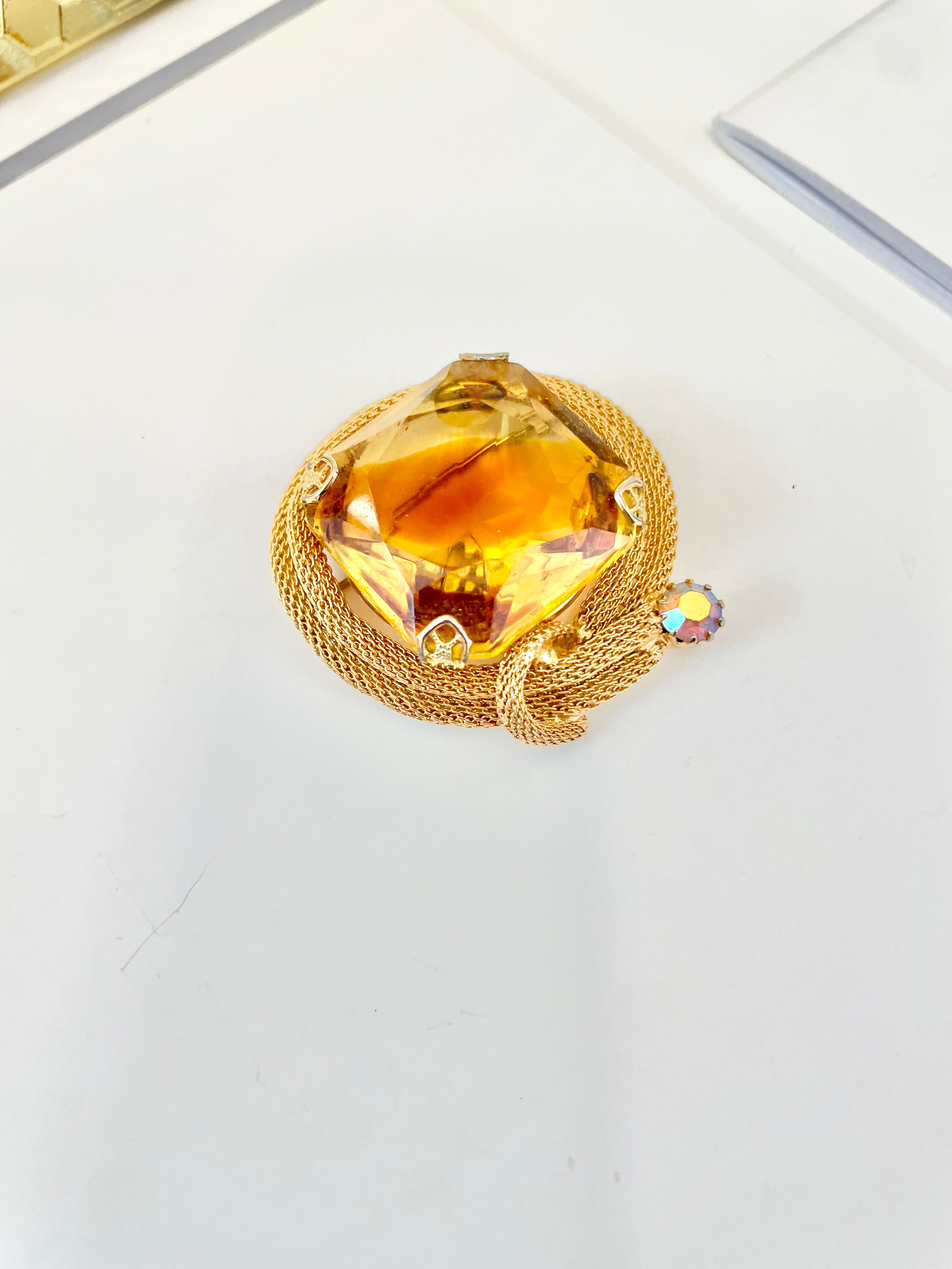 Rich and oh so classy! This stunning citrine colored glass brooch is truly chic!