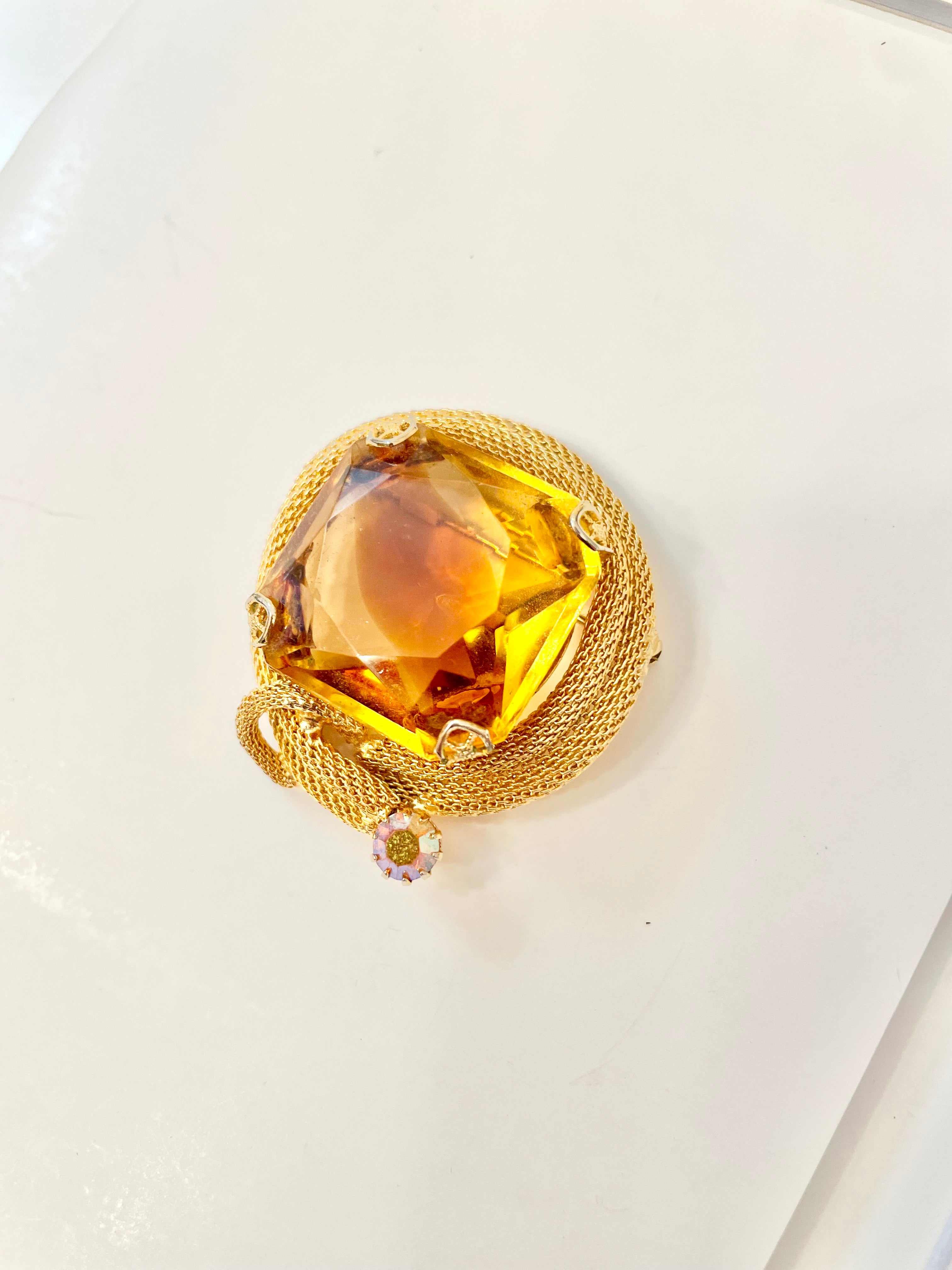 Rich and oh so classy! This stunning citrine colored glass brooch is truly chic!