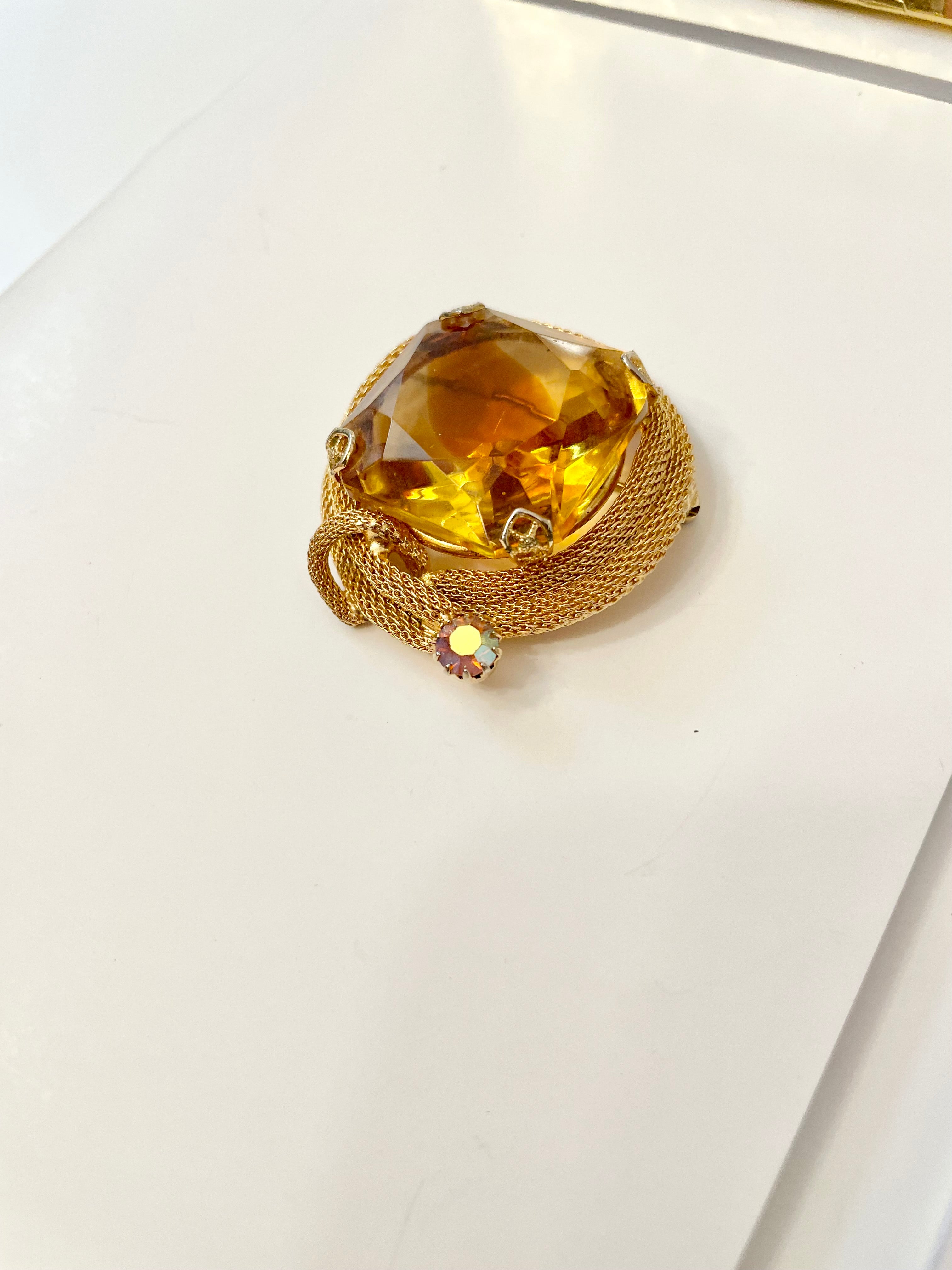 Rich and oh so classy! This stunning citrine colored glass brooch is truly chic!