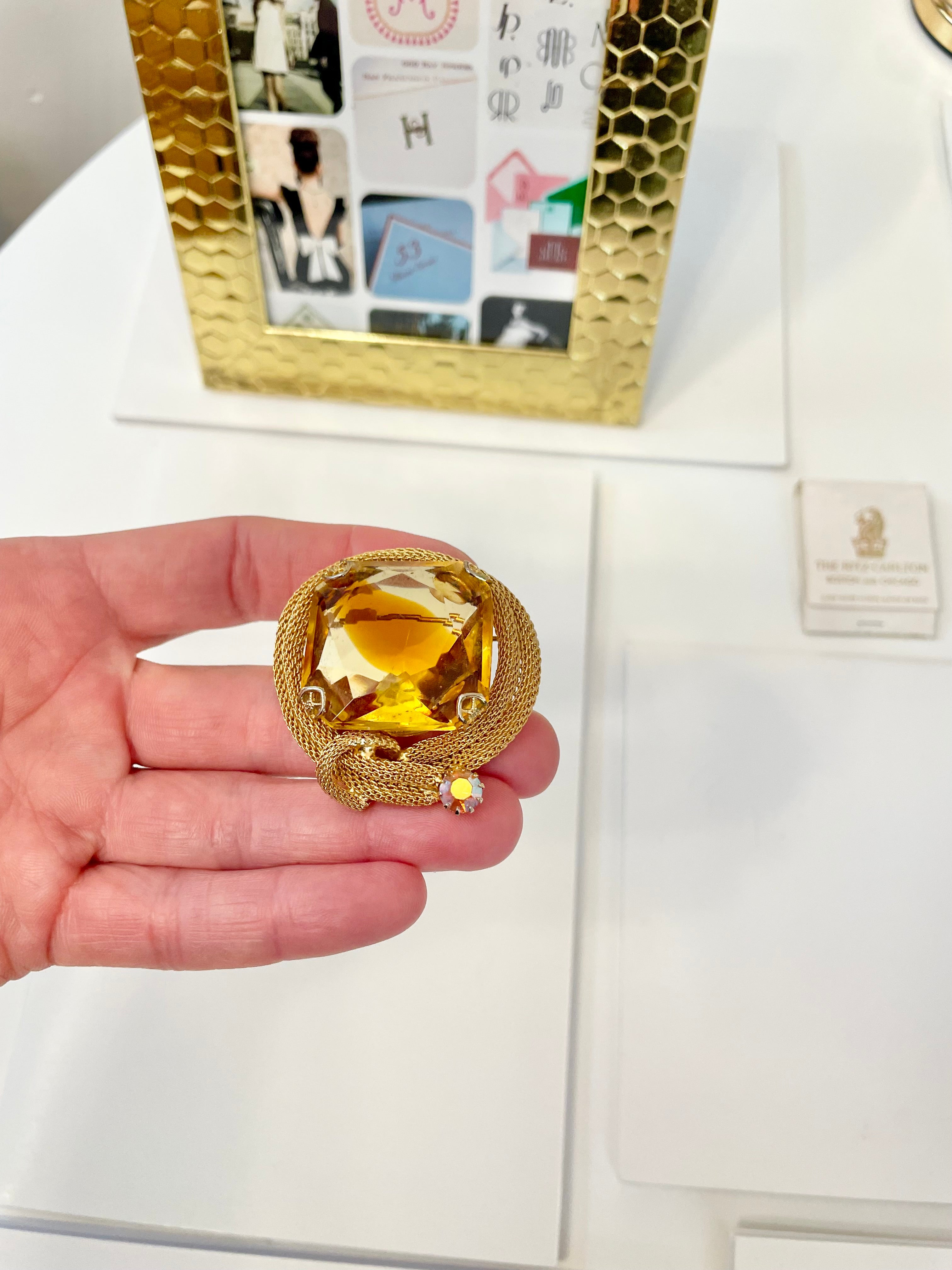 Rich and oh so classy! This stunning citrine colored glass brooch is truly chic!