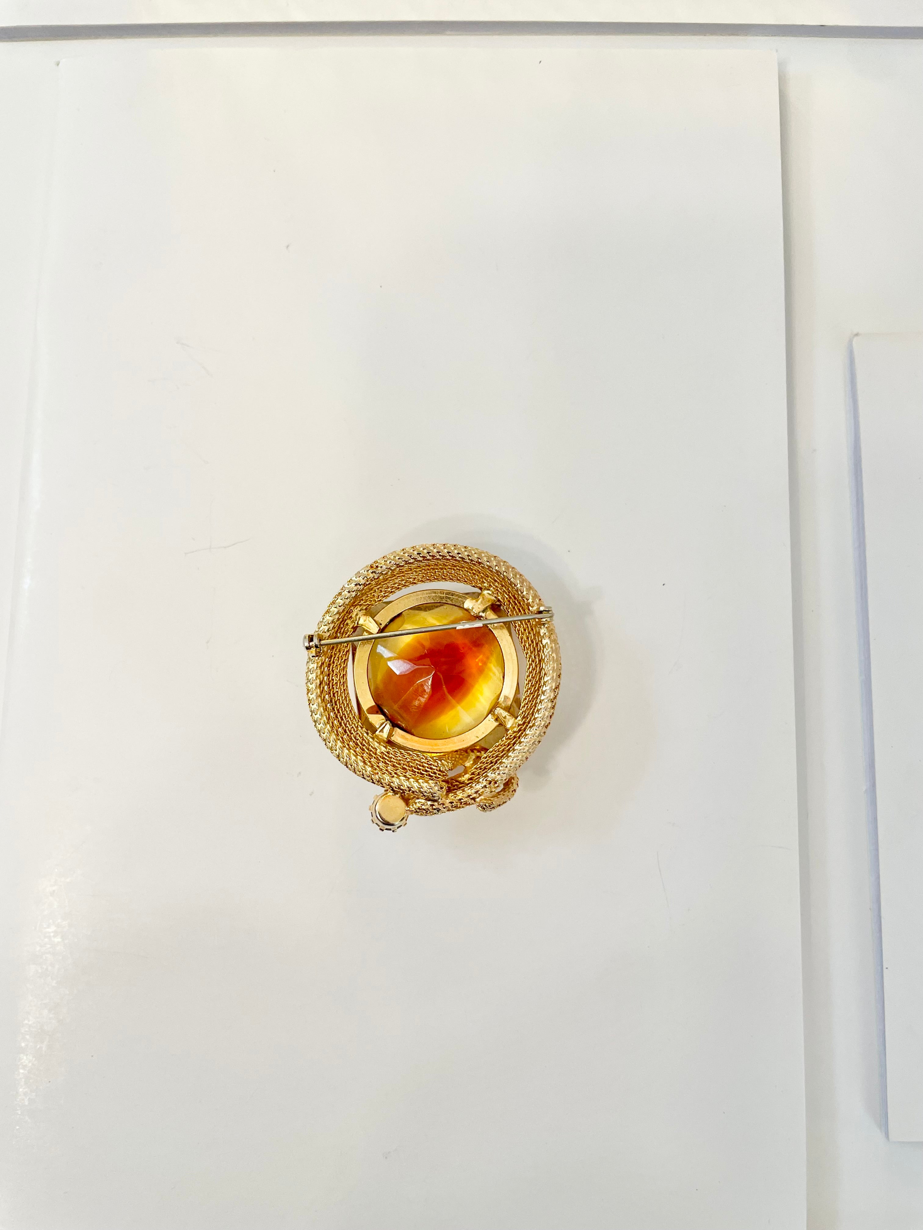 Rich and oh so classy! This stunning citrine colored glass brooch is truly chic!