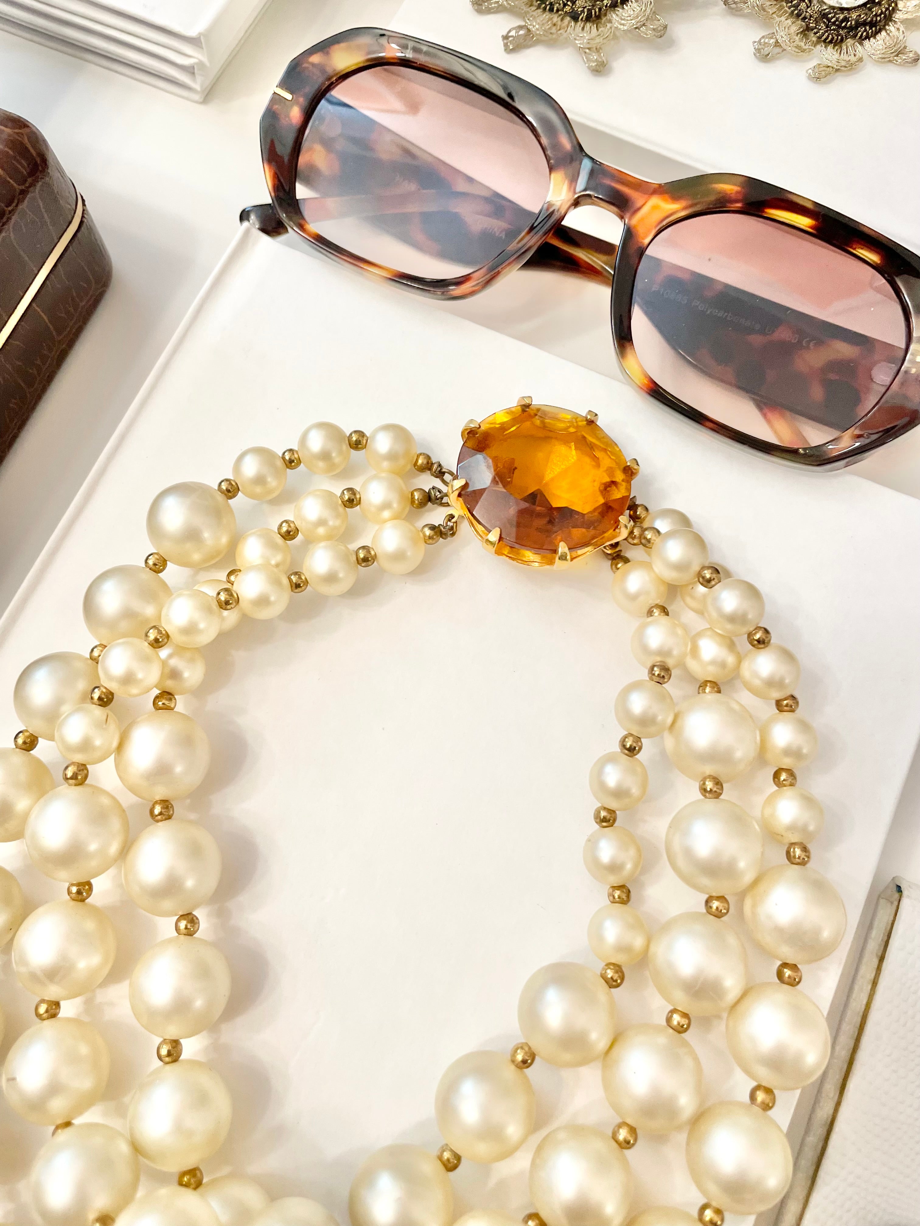 Isn't she Charming.... a fabulous three strand, large pearl necklace... with stunning amber glass clasp. Divine!!