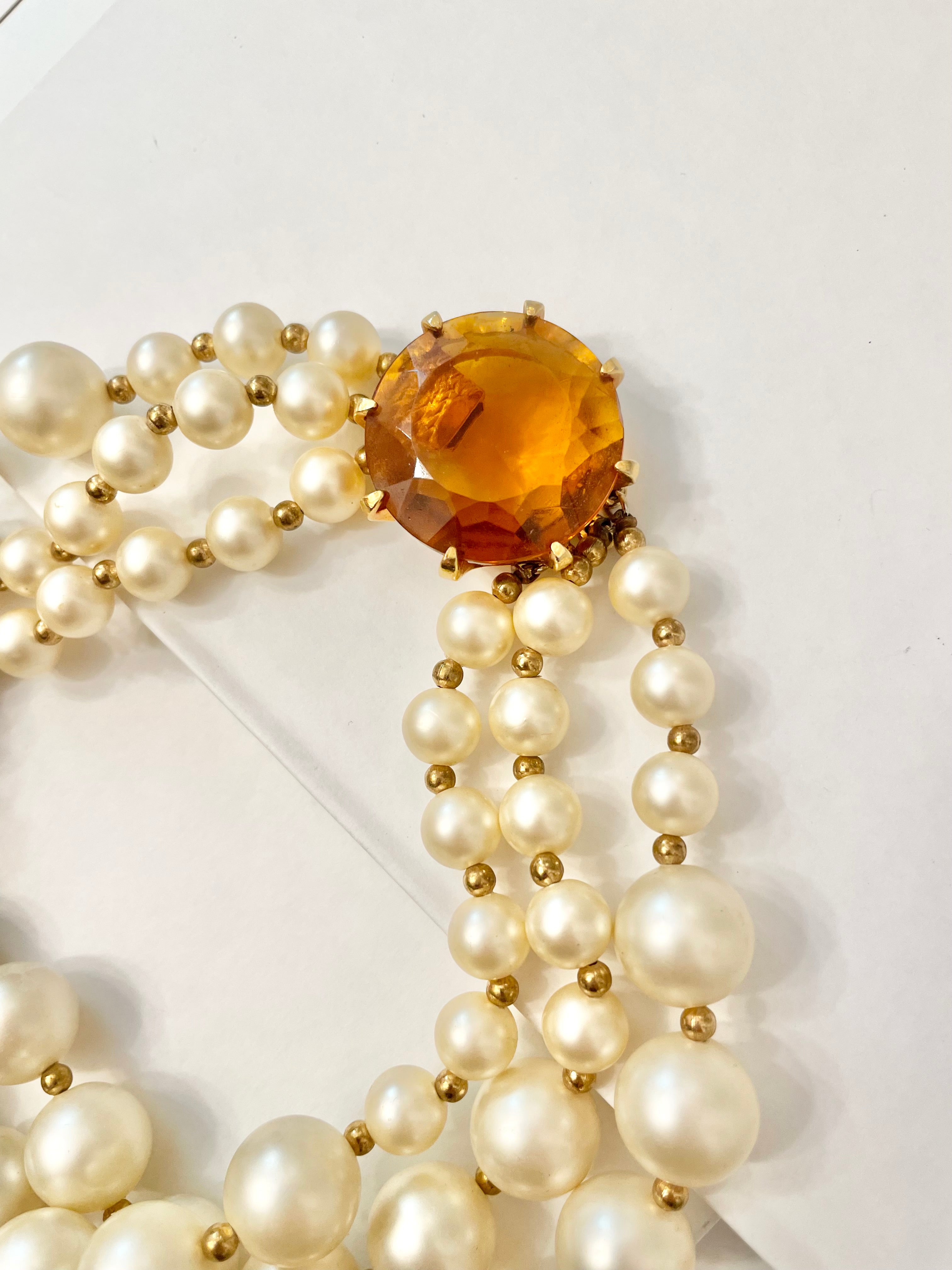 Isn't she Charming.... a fabulous three strand, large pearl necklace... with stunning amber glass clasp. Divine!!