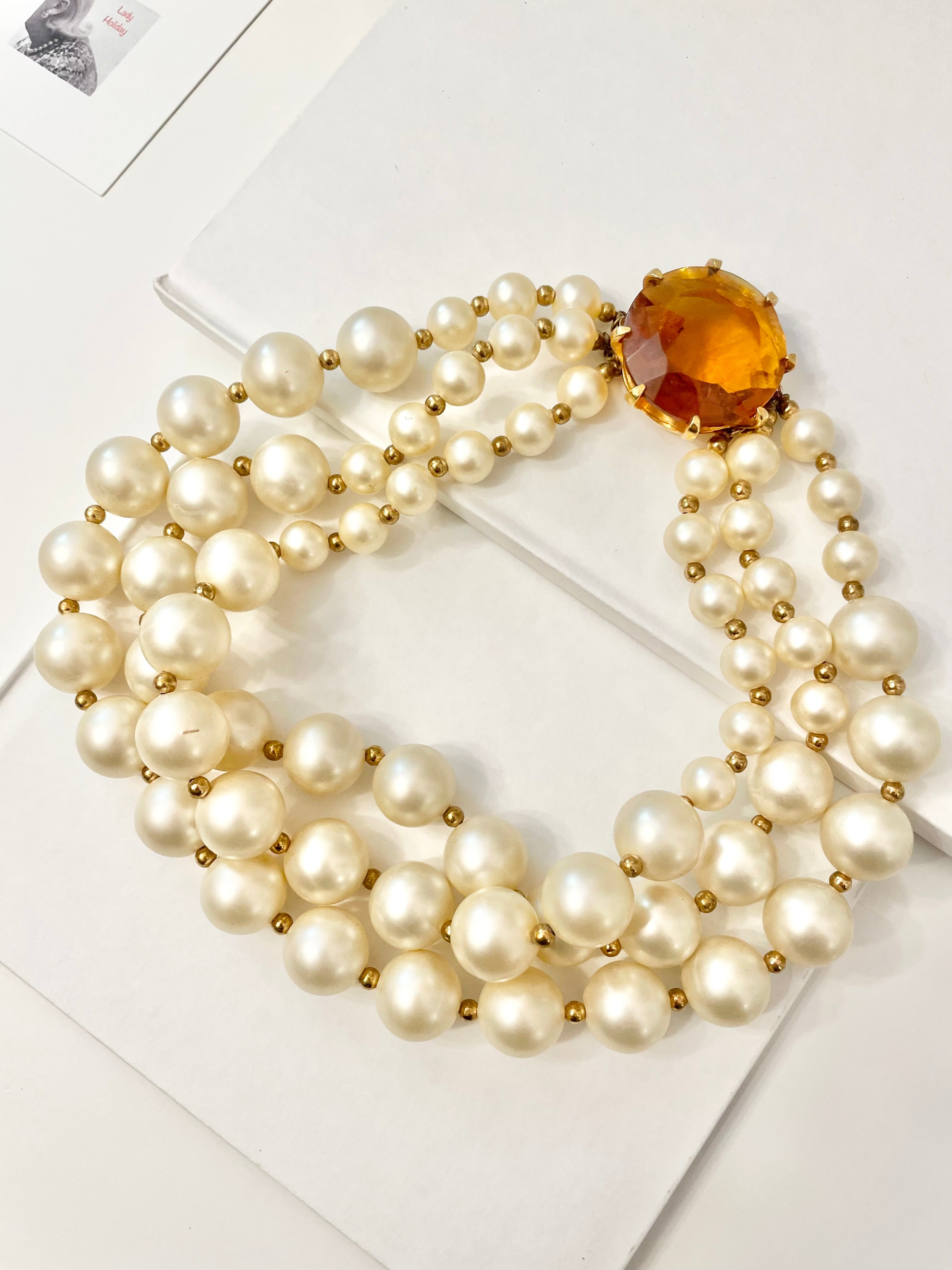 Isn't she Charming.... a fabulous three strand, large pearl necklace... with stunning amber glass clasp. Divine!!