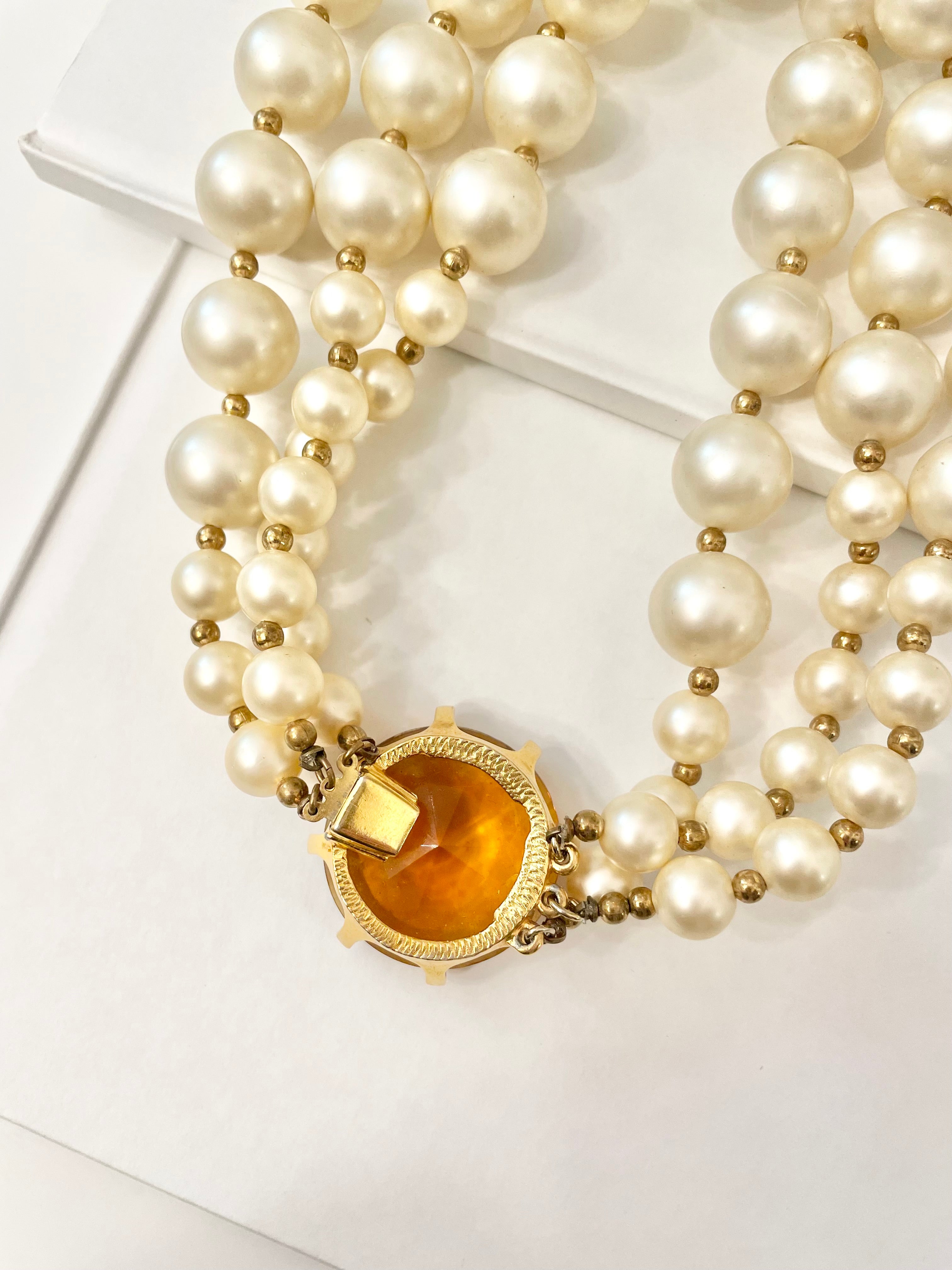 Isn't she Charming.... a fabulous three strand, large pearl necklace... with stunning amber glass clasp. Divine!!