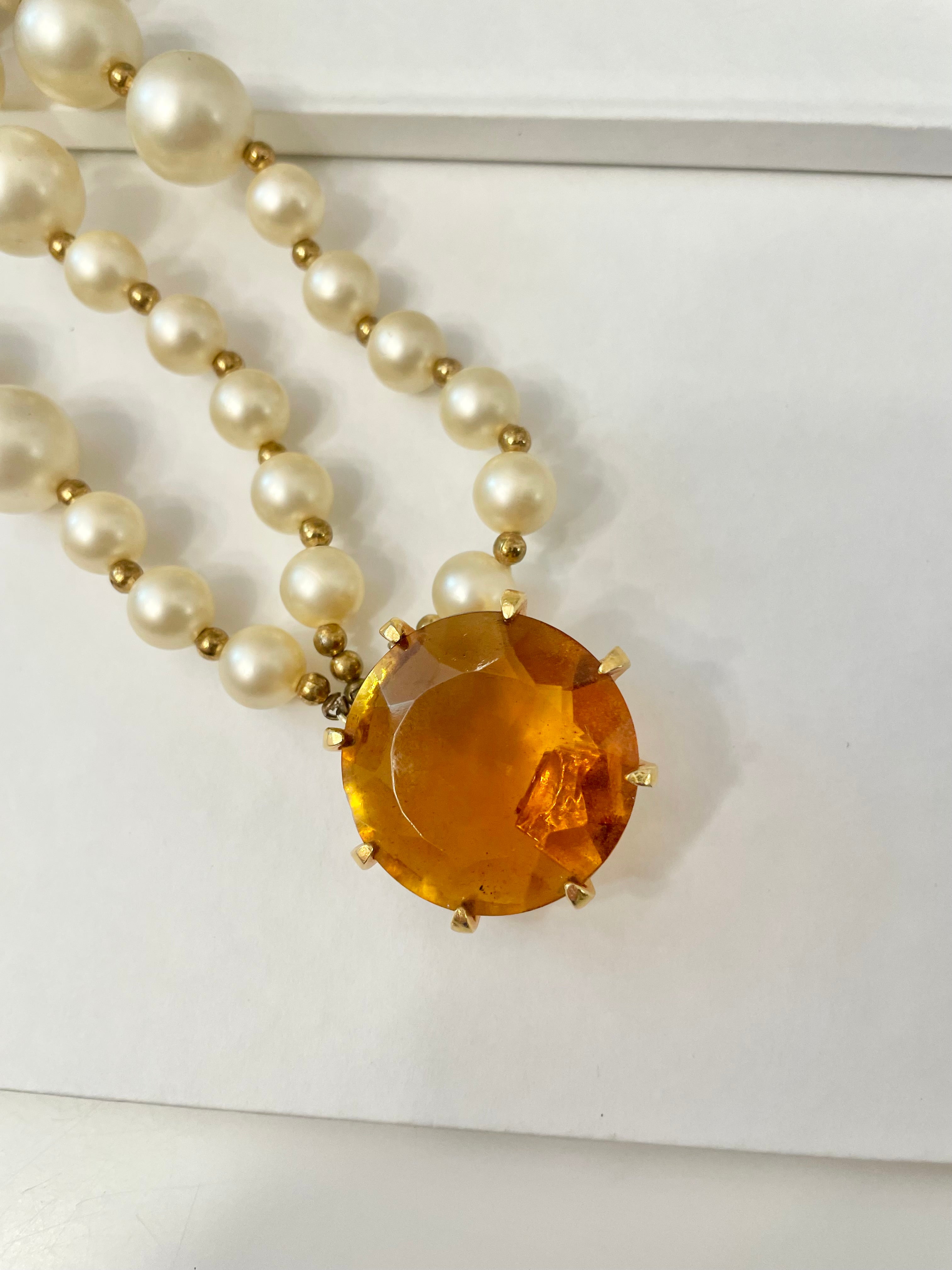 Isn't she Charming.... a fabulous three strand, large pearl necklace... with stunning amber glass clasp. Divine!!