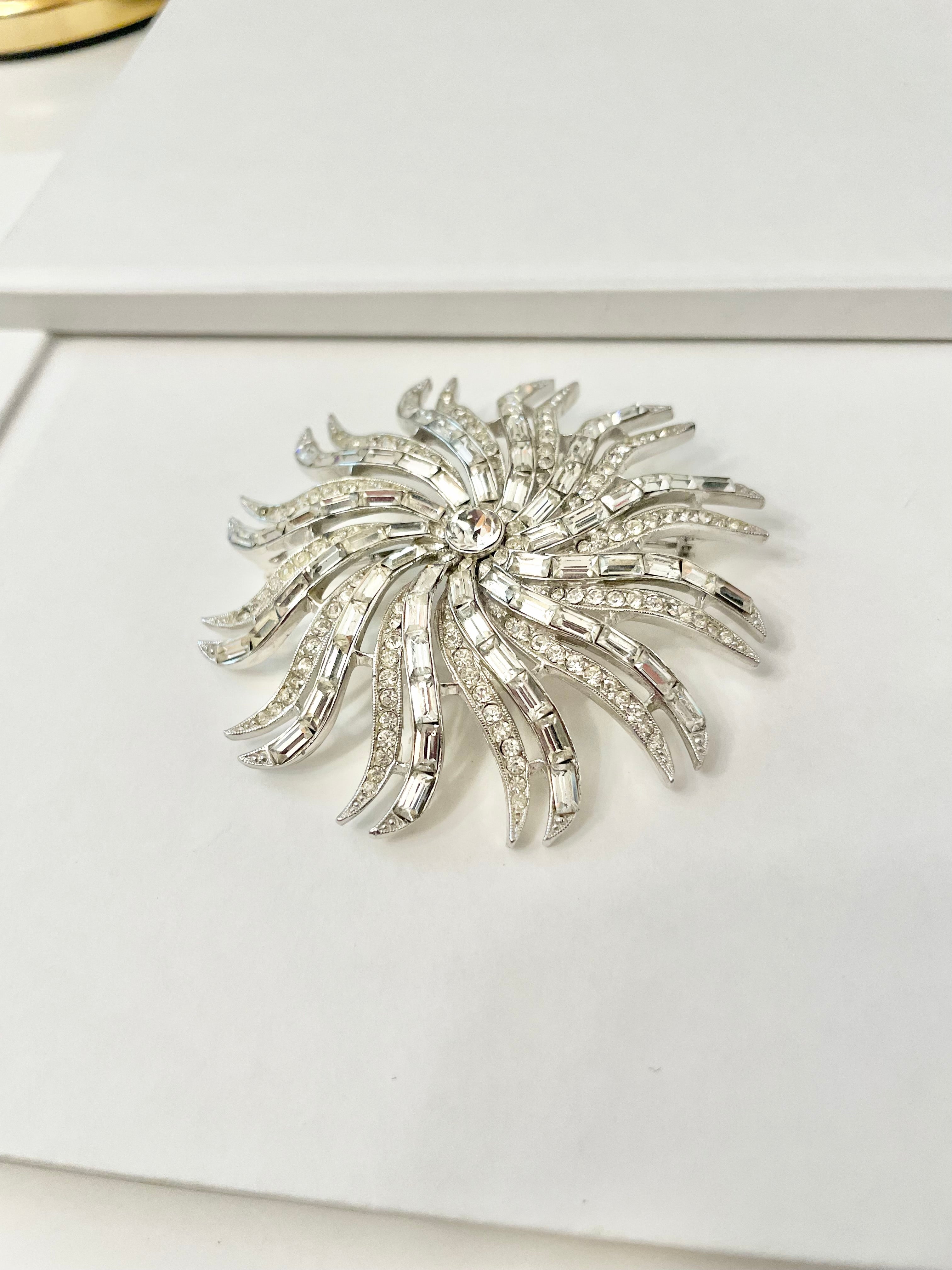 The 1960's Heiress and her diamond collection.. Oh my..this glass starburst brooch is so divine!!