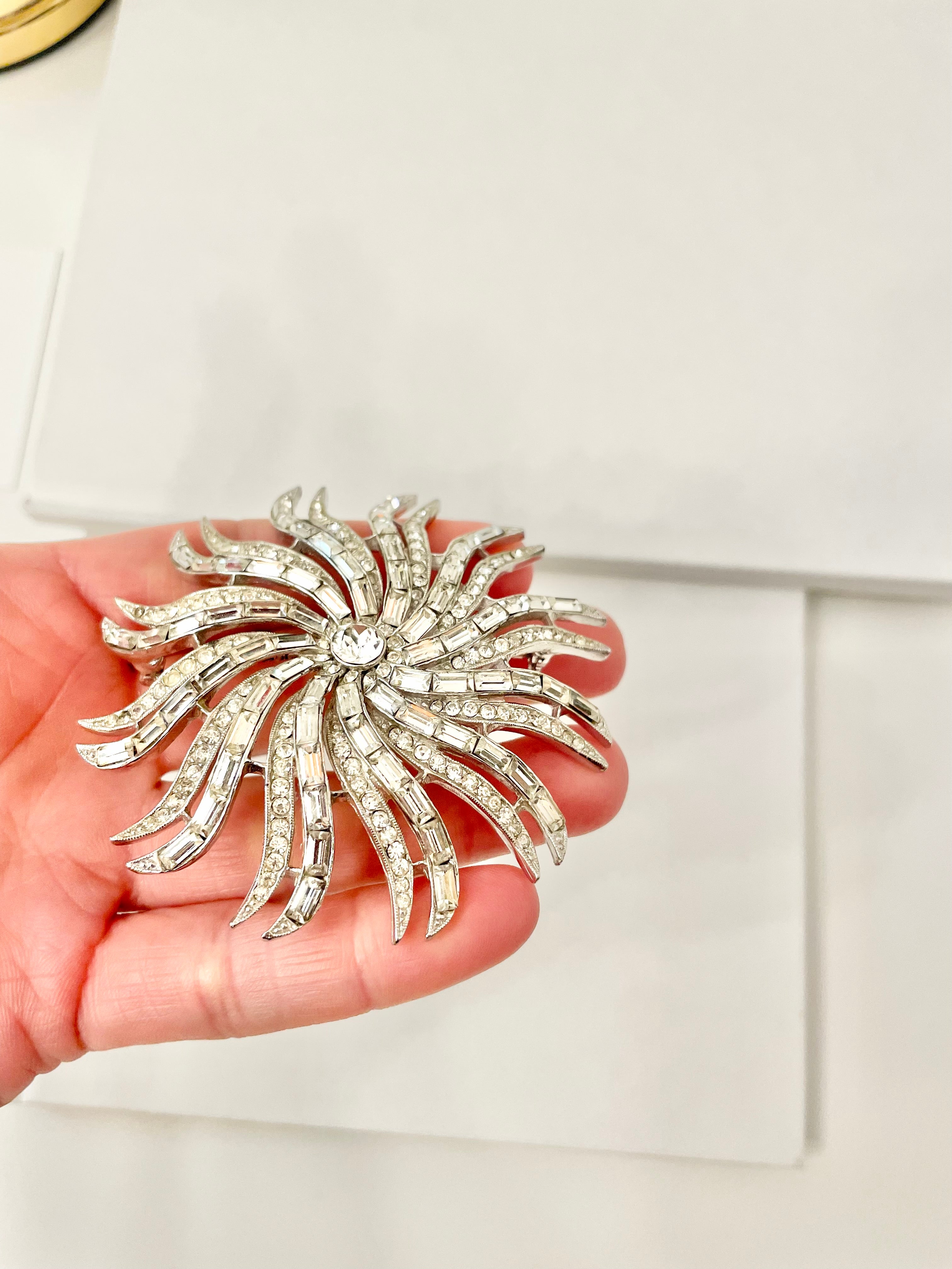 The 1960's Heiress and her diamond collection.. Oh my..this glass starburst brooch is so divine!!