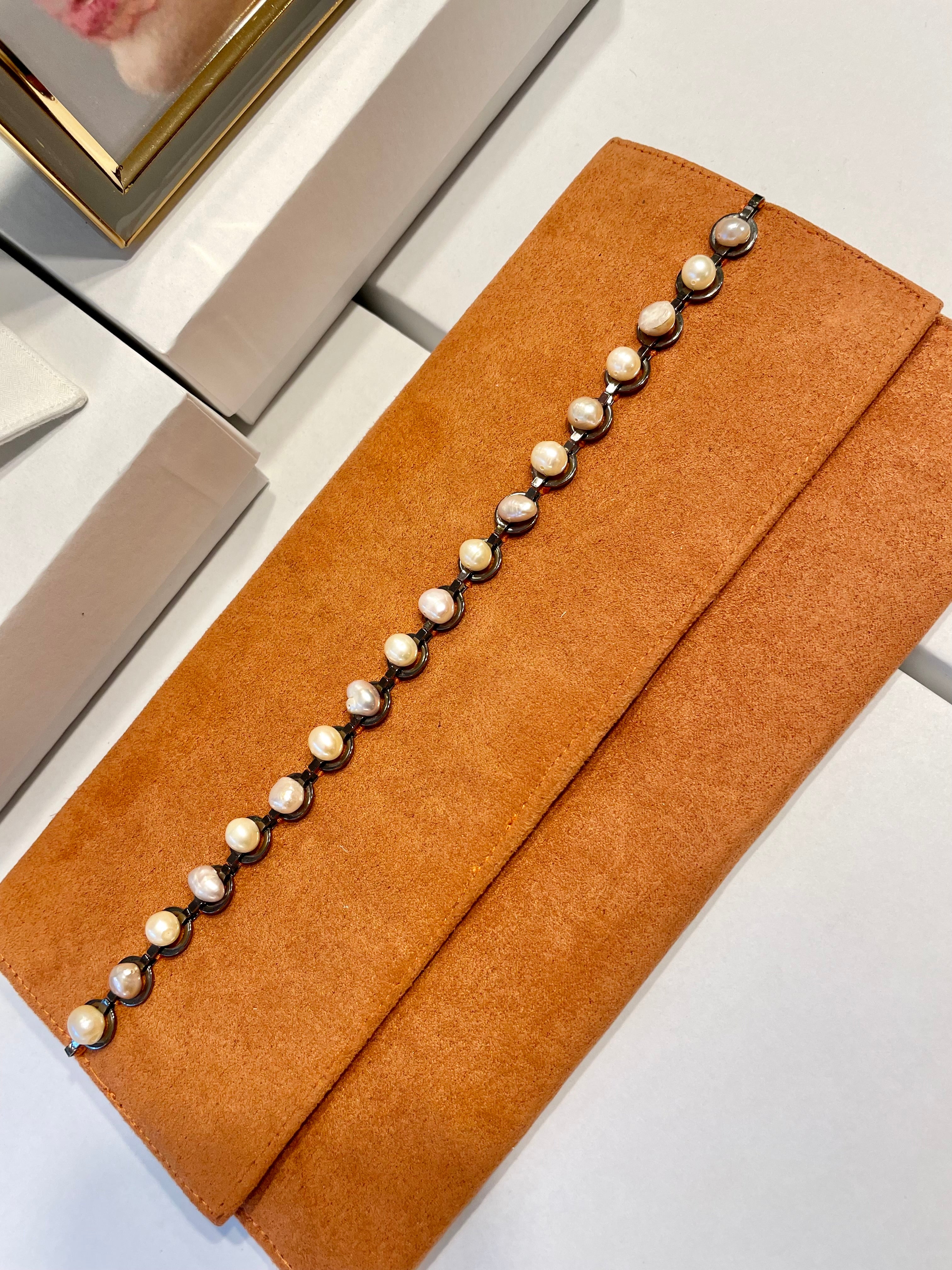Isn't she Charming... she adores anything with pearls! This one of a kind fresh water pearl clutch, is so chic!
