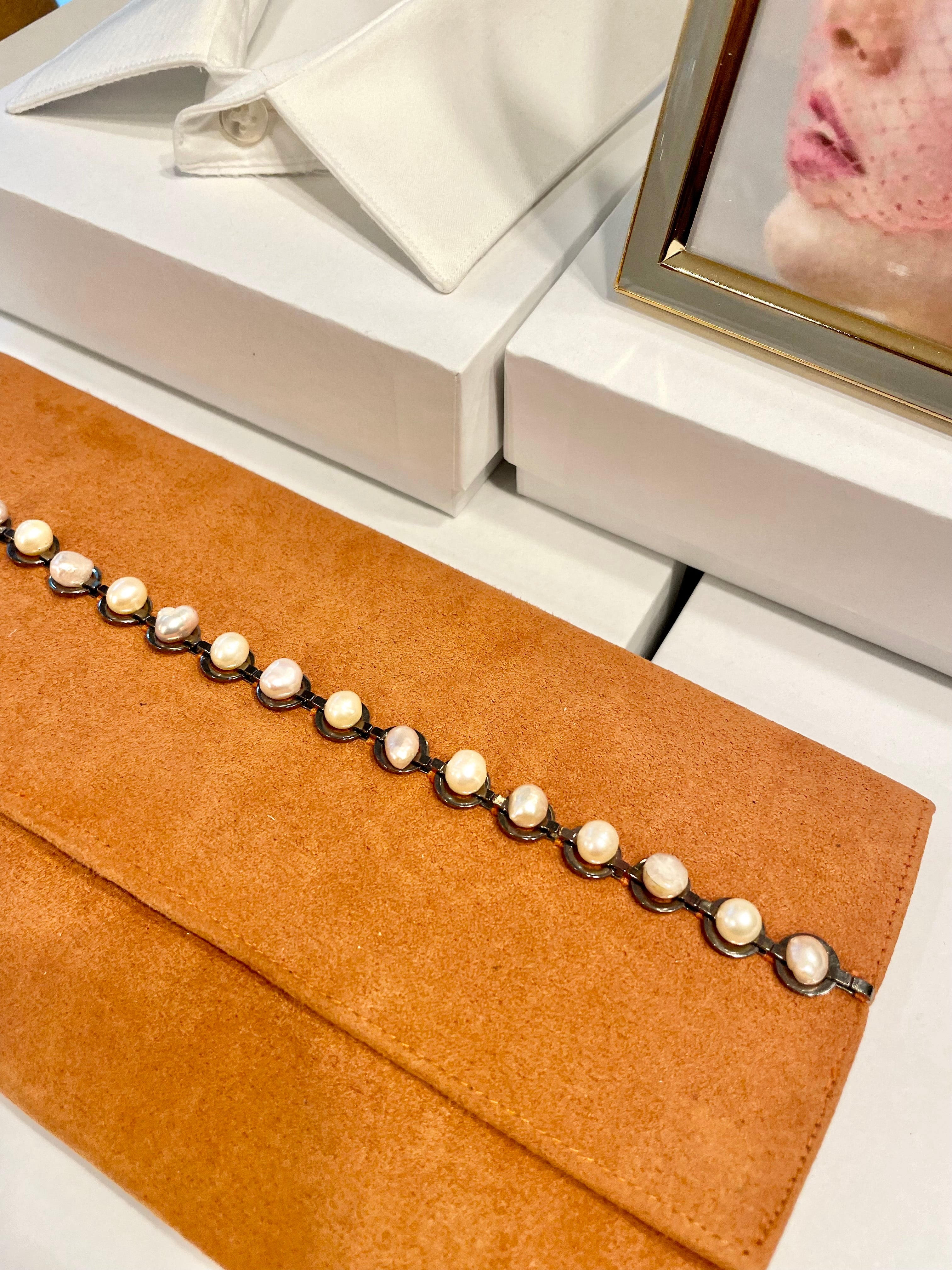 Isn't she Charming... she adores anything with pearls! This one of a kind fresh water pearl clutch, is so chic!