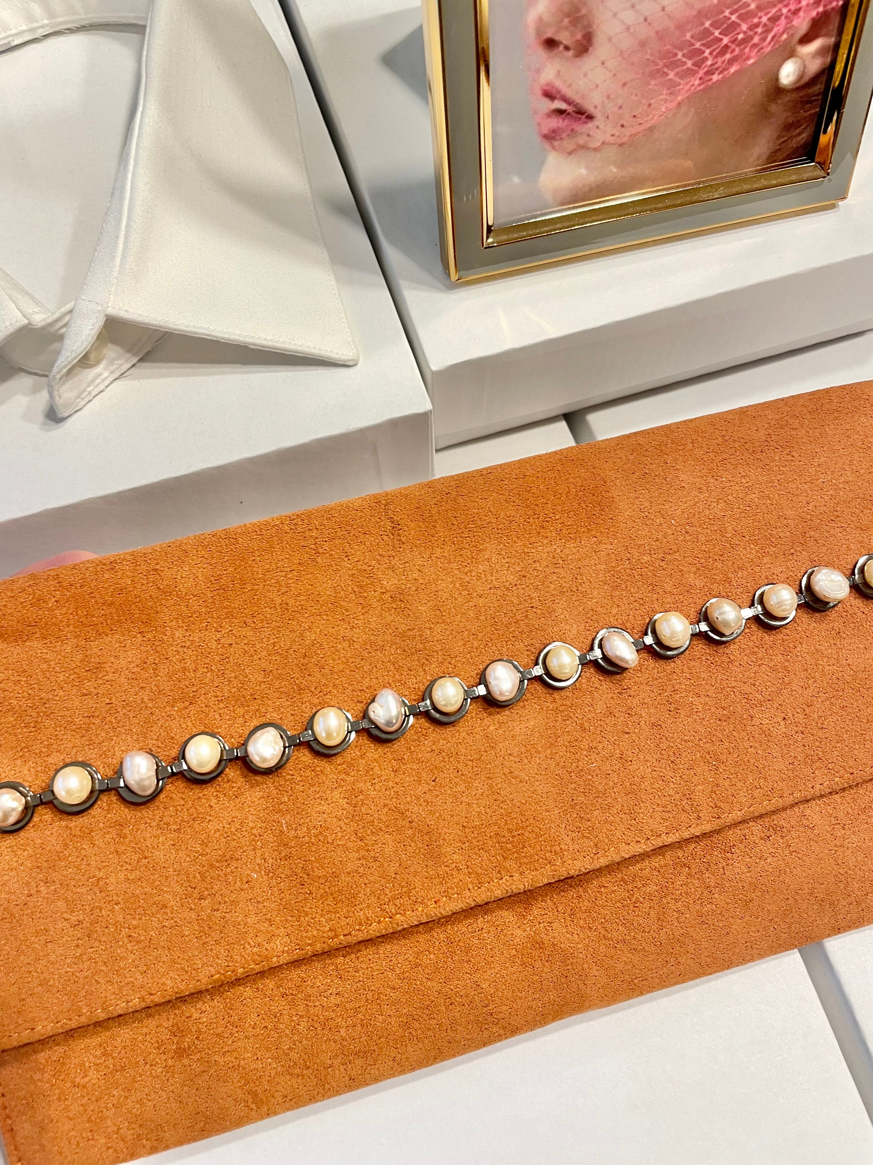 Isn't she Charming... she adores anything with pearls! This one of a kind fresh water pearl clutch, is so chic!