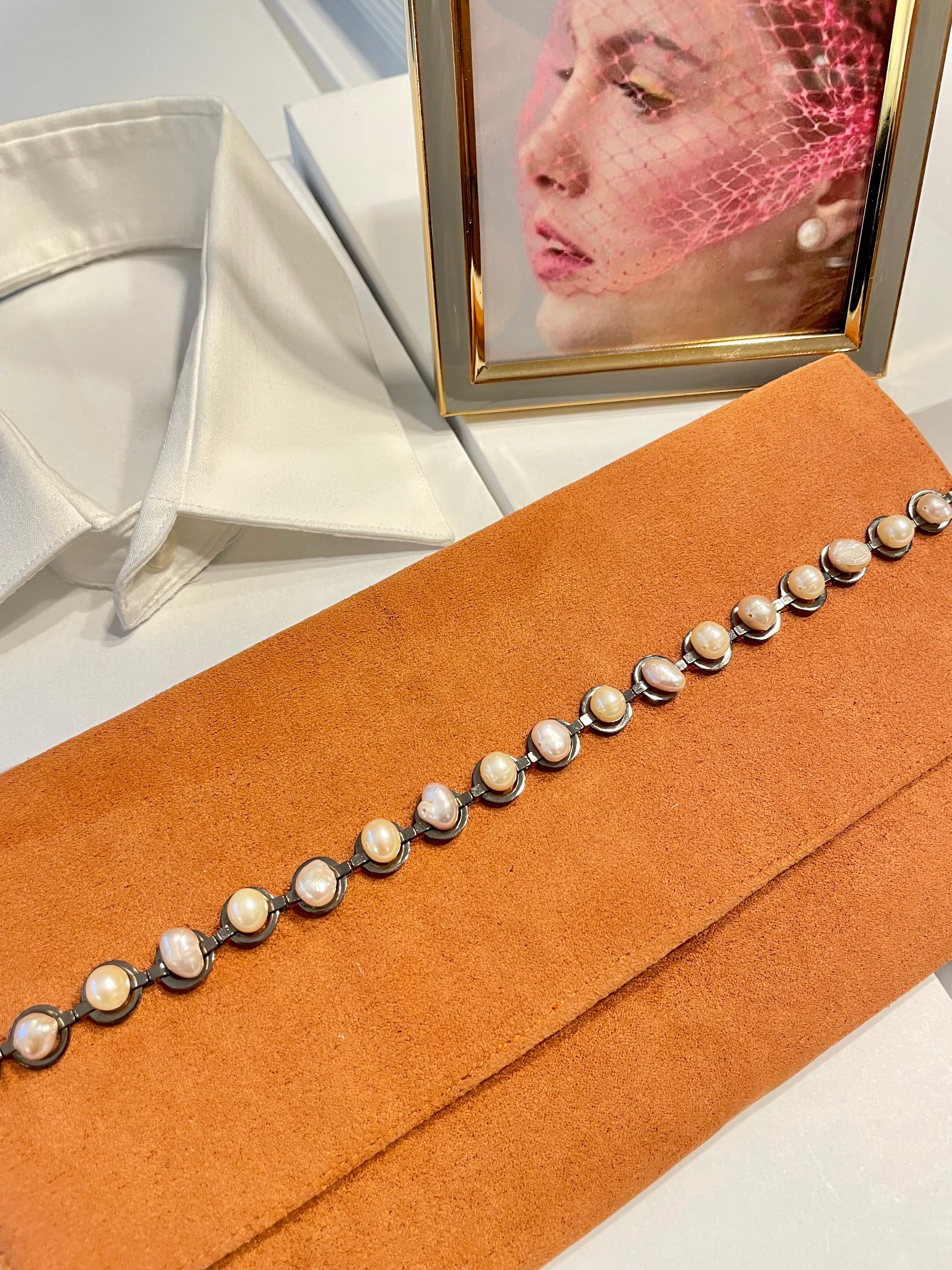 Isn't she Charming... she adores anything with pearls! This one of a kind fresh water pearl clutch, is so chic!