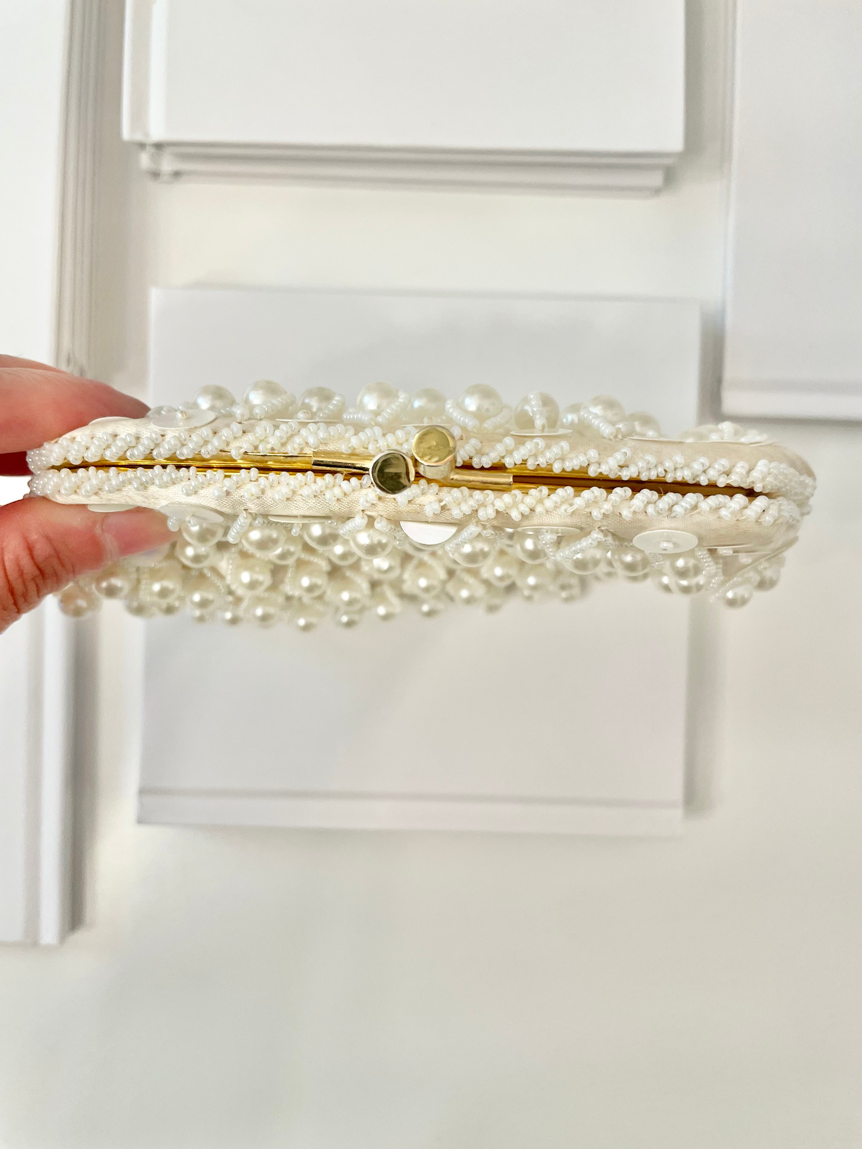 This 1960's classy pearl cha cha evening bag... is a must for any lady!