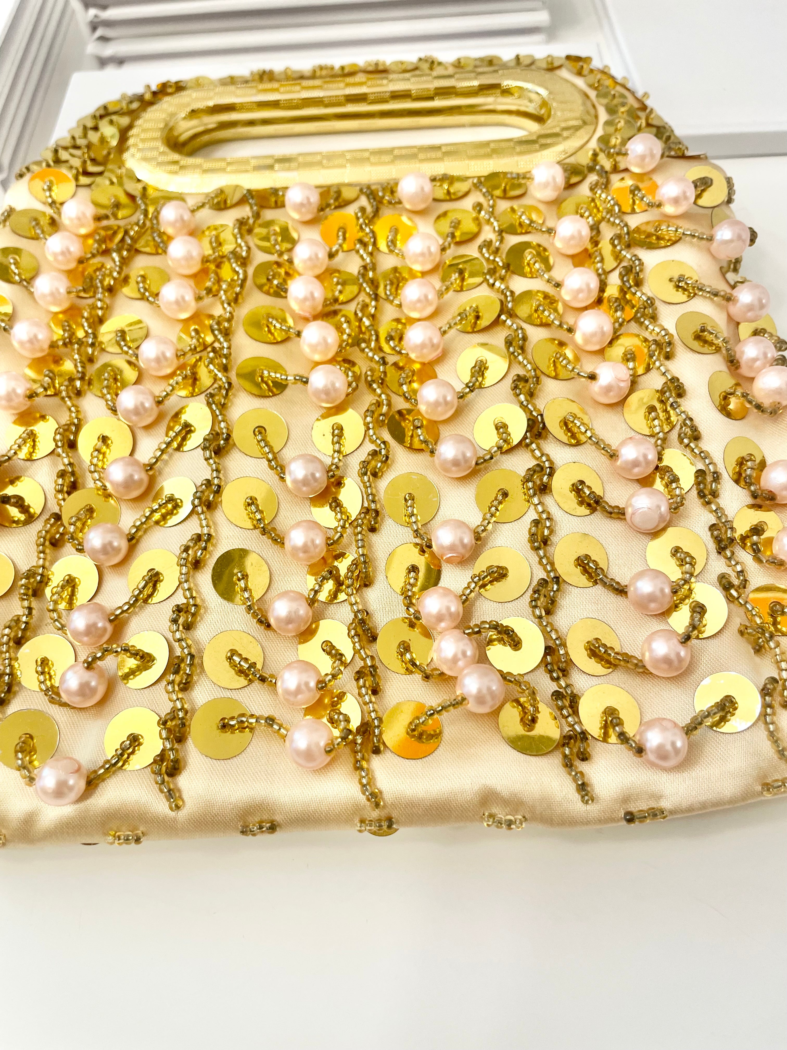 A truly lovely 1960's gold and soft blush cha cha evening bag... a elegant little number!