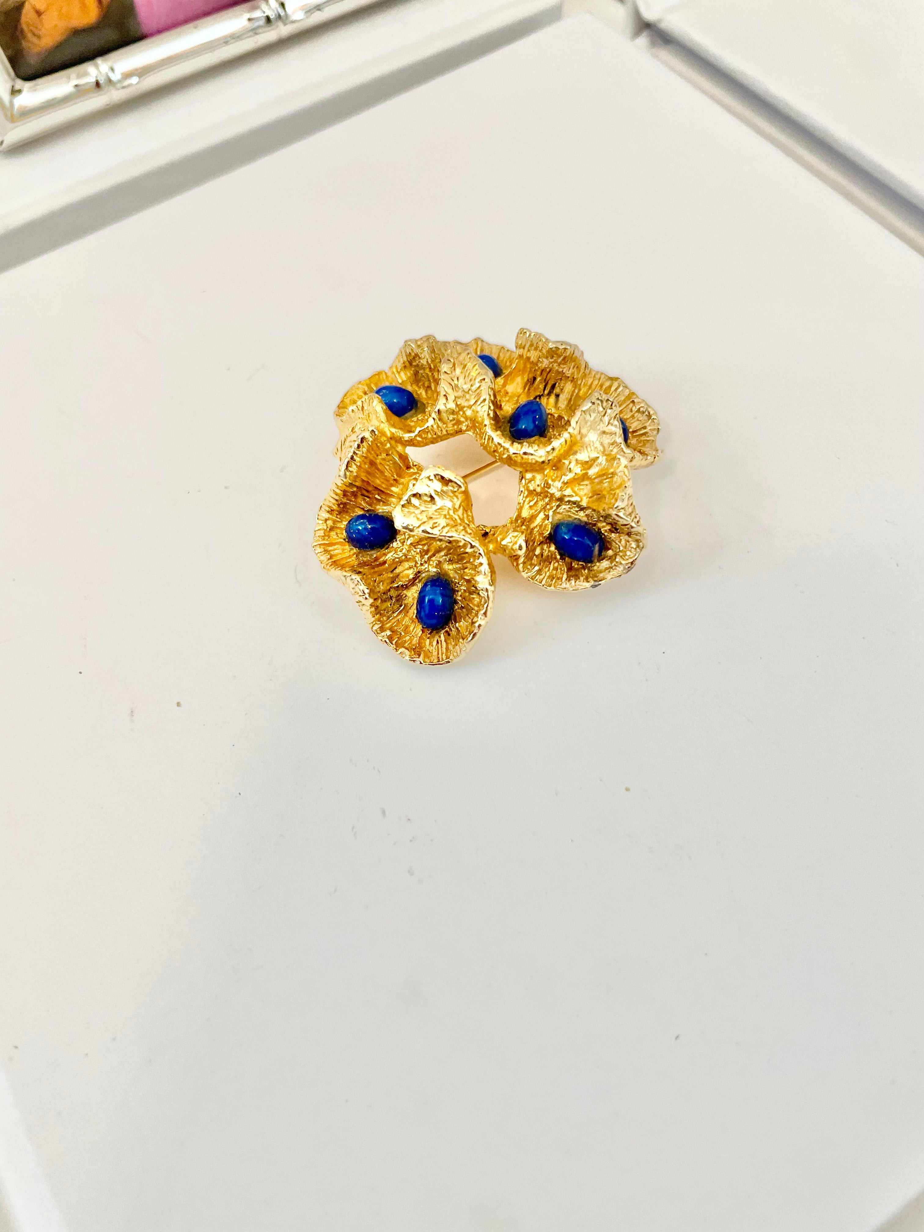 The most chic sculpted gold brooch with faux lapis stones.... so brilliant!