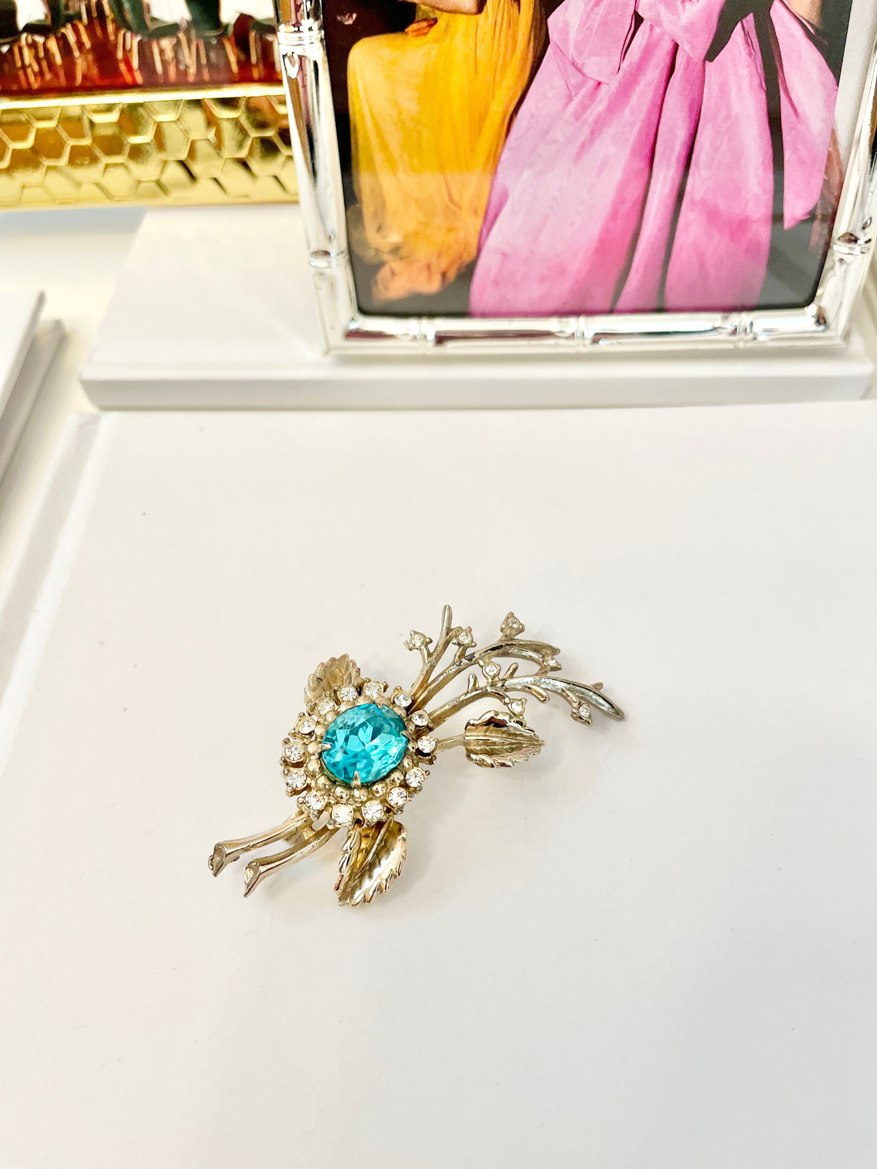 The happy hostess loves a colorful brooch... oh so divine!